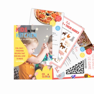 May include: A collection of colorful recipe cards and a cookbook titled "Kids in the Kitchen" with the text "School Holiday Edition". The cookbook cover features a child cooking. Other cards include recipes and a maze game.