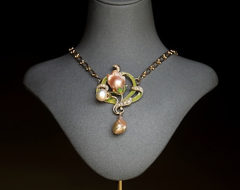 May include: A gold necklace with a pink and green enamel flower pendant and pearl accents.