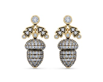 May include: A pair of gold-toned acorn earrings. Each earring features a domed acorn shape encrusted with small, clear gemstones. Above the acorn is a stylized leaf design with more gemstones and a round gemstone at the top.