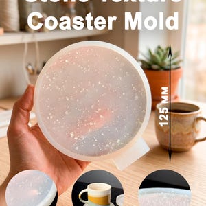 May include: A white ceramic mug with a black handle and the text "But First, Coffee" in a black, handwritten-style font. The mug is on a white surface.