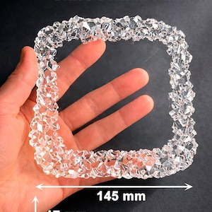 May include: Clear silicone mould in a square shape with a textured, crystal-like border. The mould is 14.5 cm wide and 1.7 cm thick. The text "SILICONE MOLD" is at the top.