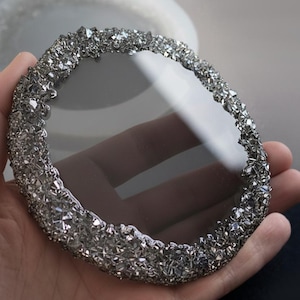 May include: A set of three ceramic mugs with a speckled, matte finish in cream, light grey, and dark grey. Each mug has a simple, minimalist design and a rounded handle.