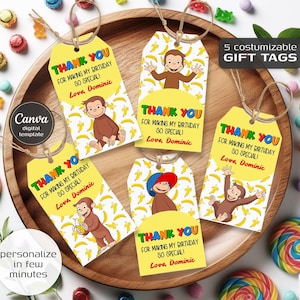 May include: Five yellow gift tags with brown string, featuring a cartoon monkey and banana pattern. Each tag says "Thank You" and "For Making My Birthday So Special!" with a personalized name. The tags are on a wooden tray.