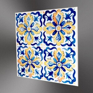 May include: Four square ceramic tiles with a blue and yellow floral pattern. The tiles have a white background and feature a repeating design of stylised flowers with blue and yellow petals.