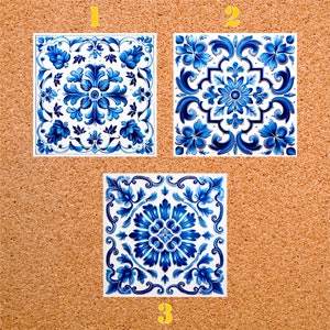 May include: Three blue and white ceramic tiles with intricate floral patterns. The tiles are arranged in a row, with the numbers 1, 2, and 3 written below them.