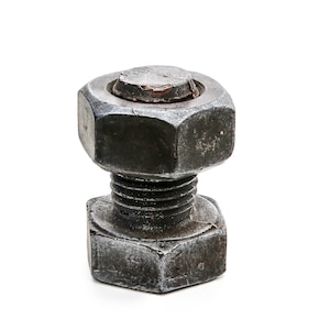 May include: A large, rusty metal bolt and nut. The nut is hexagonal and the bolt has a threaded shaft.