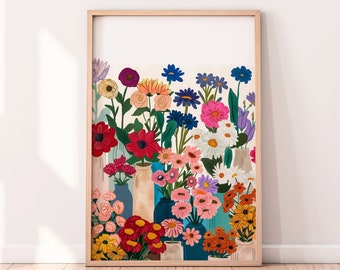 May include: A framed print of a colorful still life featuring a variety of flowers in different shades of pink, red, blue, yellow, and white arranged in a row of vases. The flowers are depicted in a stylized, illustrative style.