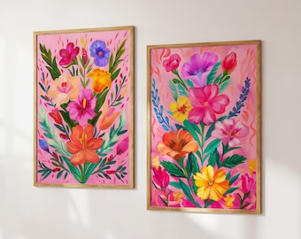 May include: Two framed floral prints with a pink background and colorful flowers. The flowers are painted in a vibrant style with a variety of colors, including pink, red, orange, yellow, and blue.
