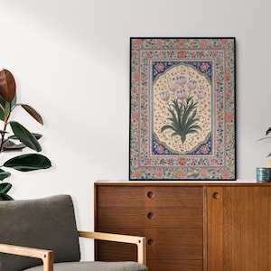 May include: A framed print of a floral design with pink flowers and green leaves on a cream background. The frame is black and the design is surrounded by a colorful border.