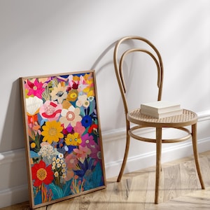May include: A framed print of a colorful floral illustration. The print features a variety of flowers in shades of pink, red, yellow, blue, and green. The flowers are arranged in a dense, layered pattern, creating a sense of depth and movement. The print is framed in a simple wooden frame.