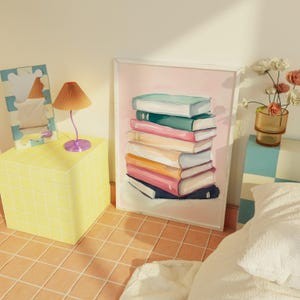 May include: A framed illustration of a stack of colorful books on a pink background. The books are arranged in a staggered pattern, with the top book being the largest and the bottom book being the smallest. The books are all different colors, including pink, blue, green, and yellow.