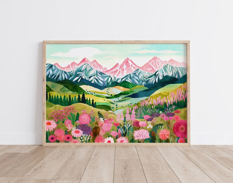 May include: A watercolor painting of a mountain range with pink peaks and a valley filled with wildflowers. The mountains are in the background and the wildflowers are in the foreground. The painting is framed in a light wood frame.