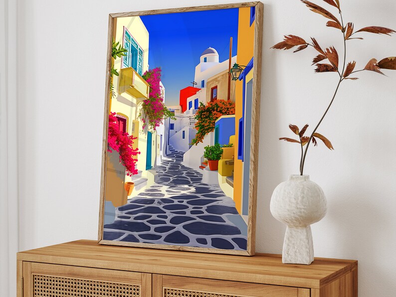 May include: A colorful painting of a narrow street in a Mediterranean village. The street is lined with white buildings with blue accents and vibrant pink flowers. The cobblestone street is shaded by a blue sky.