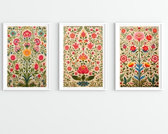 May include: Three framed prints with a floral pattern. Each print features a central flower with a pink, red, and yellow color scheme. The flowers are surrounded by smaller flowers and leaves in shades of green, blue, and white.