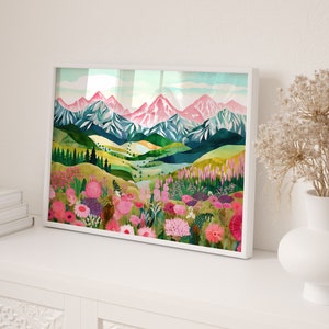 May include: A framed watercolor painting of a mountain landscape with pink and green hues. The mountains are covered in snow and the foreground features a field of pink and purple flowers.