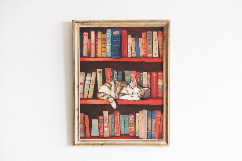 May include: A framed painting of a white and tabby cat sleeping on a bookshelf filled with colorful books. The bookshelf has three shelves and is painted red. The cat is curled up on the middle shelf.