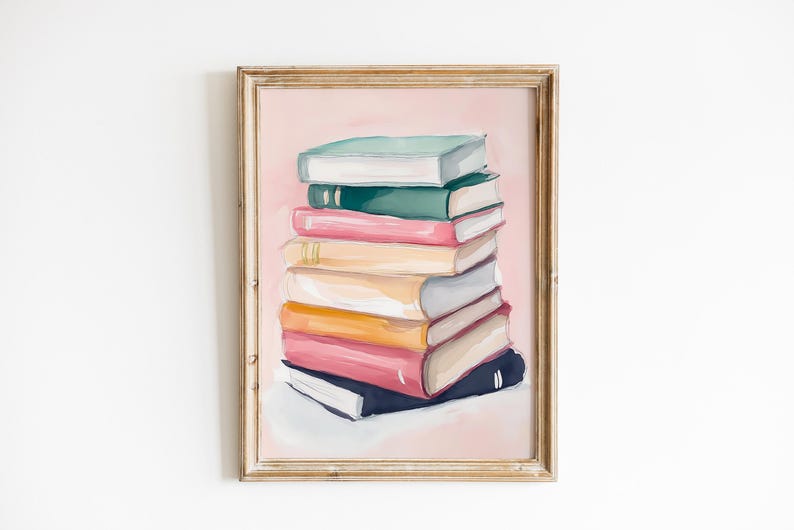May include: A framed painting of a stack of colorful books on a pink background. The books are arranged in a neat pile, with the top book being a light green color. The painting is in a simple wooden frame.