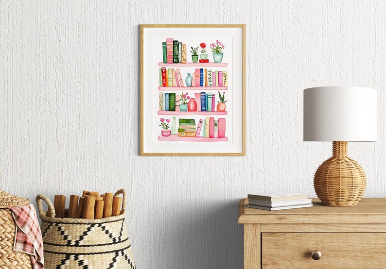 May include: Watercolor painting of a pink bookshelf with books, plants, and vases. The bookshelf has four shelves and is filled with various colored books. There are small plants and flowers in pots on each shelf. The painting is framed in a light wood frame.