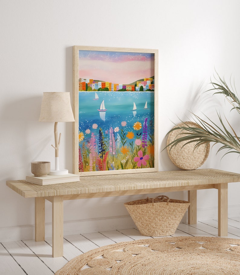 May include: A framed painting of a colorful cityscape with sailboats on a blue body of water. The foreground features a field of bright flowers in shades of pink, purple, yellow, and orange.