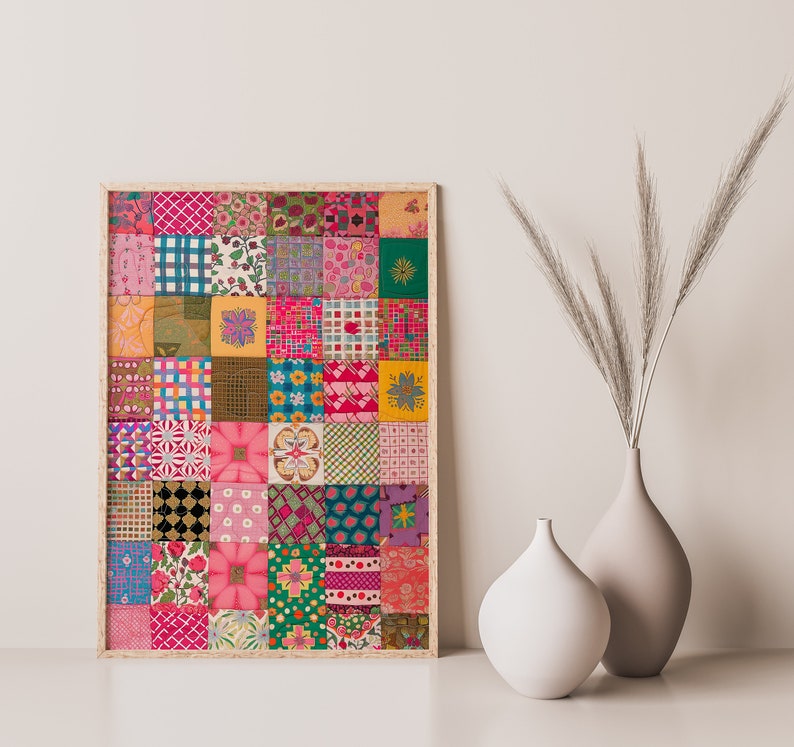May include: A framed print of a colorful patchwork quilt design with various patterns and colors, including pink, green, yellow, and blue. The print is framed in a light wood frame and is displayed on a white wall.