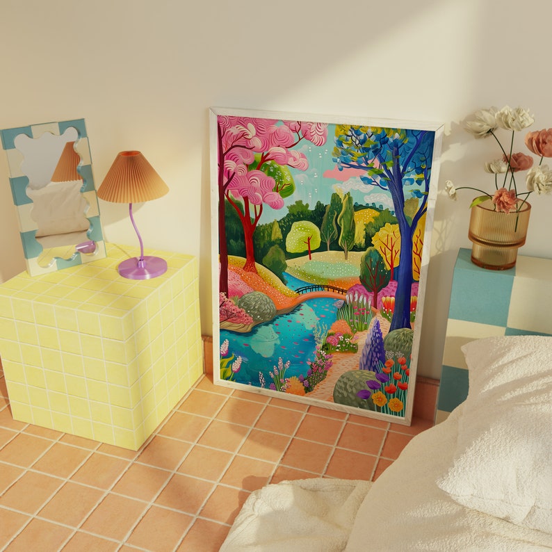 May include: A framed art print depicts a vibrant landscape with a river, bridge, and colorful trees. The artwork features pink, green, and blue hues, creating a whimsical scene. A decorative mirror, lamp, and vase of flowers are also visible.