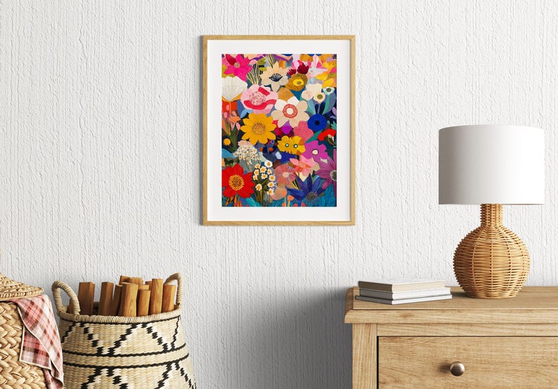 May include: A framed print of a colorful floral illustration. The flowers are in shades of pink, red, yellow, blue, and green. The background is a dark blue.