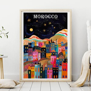 May include: A colorful illustration of a city skyline at night with the word "MOROCCO" at the top. The city is filled with colorful buildings, a crescent moon, and stars in the night sky.