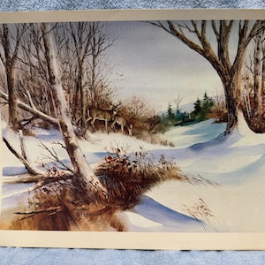 May include: Watercolor painting of a winter landscape with two deer in a snowy forest. Bare trees frame the scene, with a fallen tree in the foreground. The artwork is signed "Sherry Peterson".