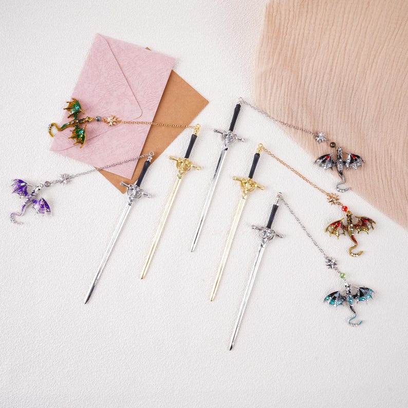 May include: Five silver and gold sword-shaped bookmarks with dragon-shaped charms. The charms are in various colors, including purple, green, red, and blue.