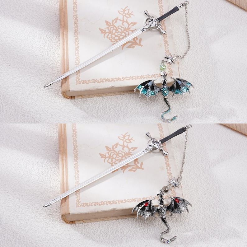 May include: Two silver sword-shaped hair clips with dangling dragon charms. One dragon is green and the other is black.