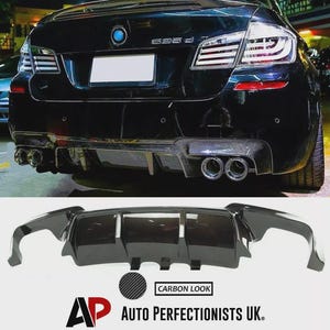 May include: Black car rear with carbon fibre accents and dual exhaust pipes. The image also shows a carbon fibre rear diffuser with the text "CARBON LOOK" and the logo for "AUTO PERFECTIONISTS UK."