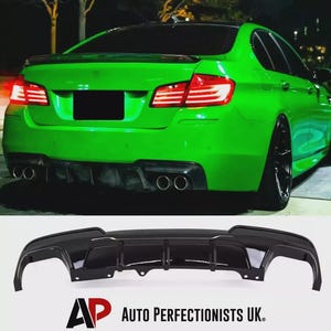 May include: A vibrant green sports car with black detailing, including a rear diffuser and exhaust pipes. The car's rear lights are lit. A separate black rear diffuser is shown below. The text "AP AUTO PERFECTIONISTS UK." is visible.