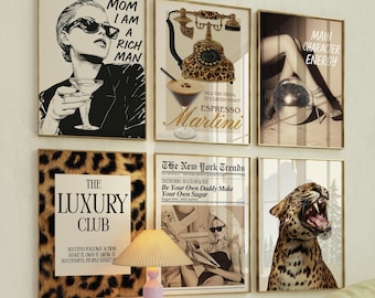 May include: A collection of framed art prints with gold frames. The prints feature various images, including a woman with sunglasses, a leopard print telephone, a martini, a disco ball, a leopard, and text that reads "MOM I AM A RICH MAN" and "THE LUXURY CLUB".