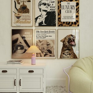 May include: A selection of framed art prints with gold frames. The prints depict diverse themes, including a leopard print, a woman with sunglasses, and a vintage telephone. One print displays the text "MOM I AM A RICH MAN."