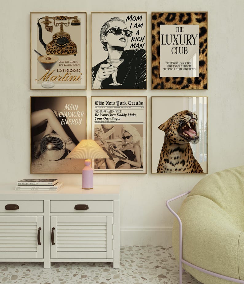 May include: A selection of framed art prints with gold frames. The prints depict diverse themes, including a leopard print, a woman with sunglasses, and a vintage telephone. One print displays the text "MOM I AM A RICH MAN."