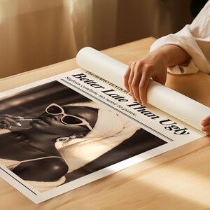May include: Black and white print featuring a woman wearing sunglasses and a towel, applying lipstick. The print has the headline "Better Late Than Ugly" and the text "Stylists confirm: no need to panic."