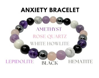 Può includere: Braccialetto per l'ansia con una varietà di perline di pietre preziose. Il braccialetto include perline di ametista, quarzo rosa, howlite bianca, lepidolite, nere ed ematite. Il testo "ANXIETY BRACELET" è visualizzato sopra.