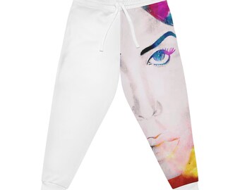 May include: White sweatpants with a colorful watercolor portrait of a person's face on the right leg. The portrait features a blue eye with pink eyelashes and a red lip.