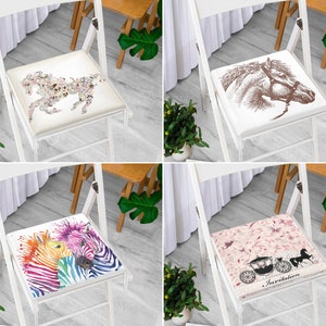 May include: Four square chair cushions with equestrian and animal designs. One cushion features a horse made of floral patterns. Another displays a brown horse head. A third cushion has two colorful zebras. The last cushion has a carriage and the word "Invitation".