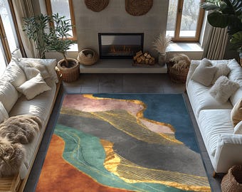 May include: A colorful area rug with an abstract design. The rug features shades of blue, orange, gray, and teal, with gold-colored linear accents. The rug is rectangular and placed in a living room setting with white sofas and a fireplace.