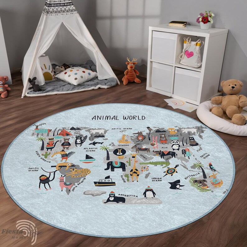 May include: A round, light blue rug with an illustrated world map featuring animals. The rug has the text "ANIMAL WORLD" and is surrounded by a wooden floor. A white teepee, toys, and a white storage unit are in the background.