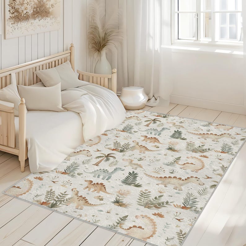 May include: A rectangular rug with a cream background features a repeating pattern of various dinosaurs, palm trees, and ferns in shades of brown, green, and blue. The rug is placed on a light wood floor in a bedroom setting.