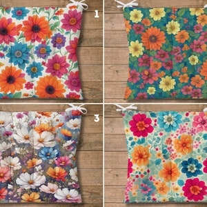 May include: Four different floral patterned chair cushions. The cushions are square and have a tie on each corner. The patterns feature various flowers in shades of pink, orange, yellow, blue, and white.