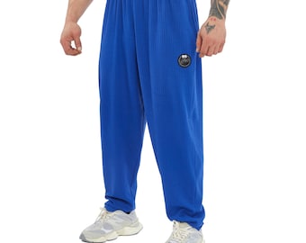May include: Royal blue sweatpants with a ribbed texture and a small black logo on the left leg.
