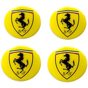 May include: Four yellow circular buttons featuring the Ferrari logo. Each button has a yellow background with the Ferrari shield, a black prancing horse, and the letters "SF" below. The shield is topped with green, white, and red stripes.