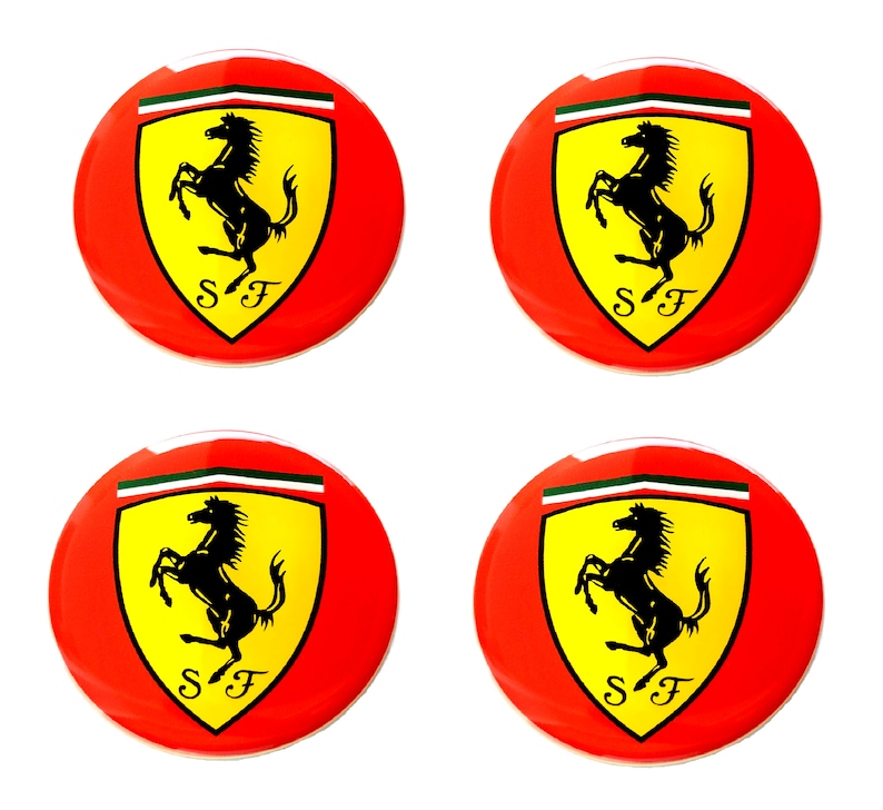 May include: Four red, round emblems featuring the Ferrari logo. Each emblem has a yellow shield with a black prancing horse and the letters "SF" at the bottom. A green and white stripe is at the top of the shield.