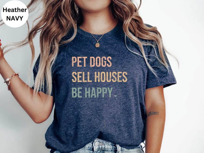 a woman wearing a realtor t - shirt that says pet dogs sell houses be happy