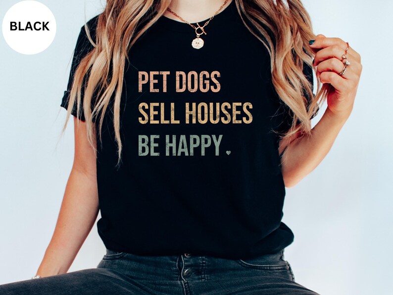 a woman wearing a realtor t - shirt that says pet dogs sell houses be happy