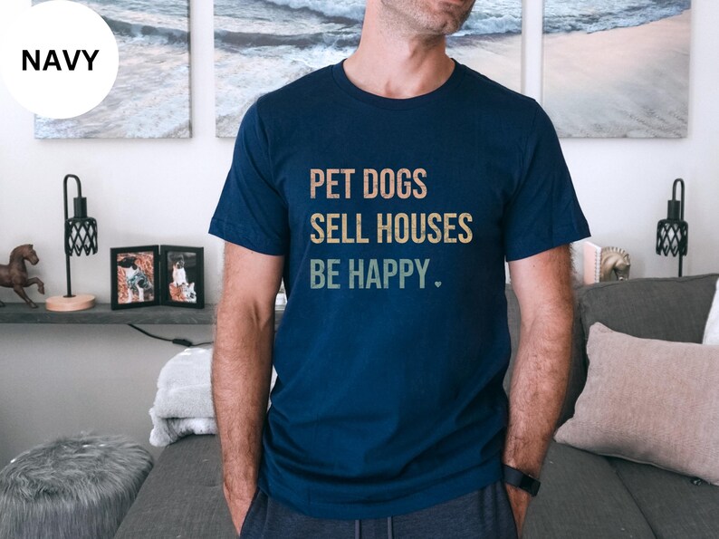a woman wearing a realtor t - shirt that says pet dogs sell houses be happy