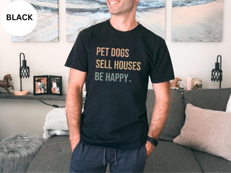 a woman wearing a realtor t - shirt that says pet dogs sell houses be happy